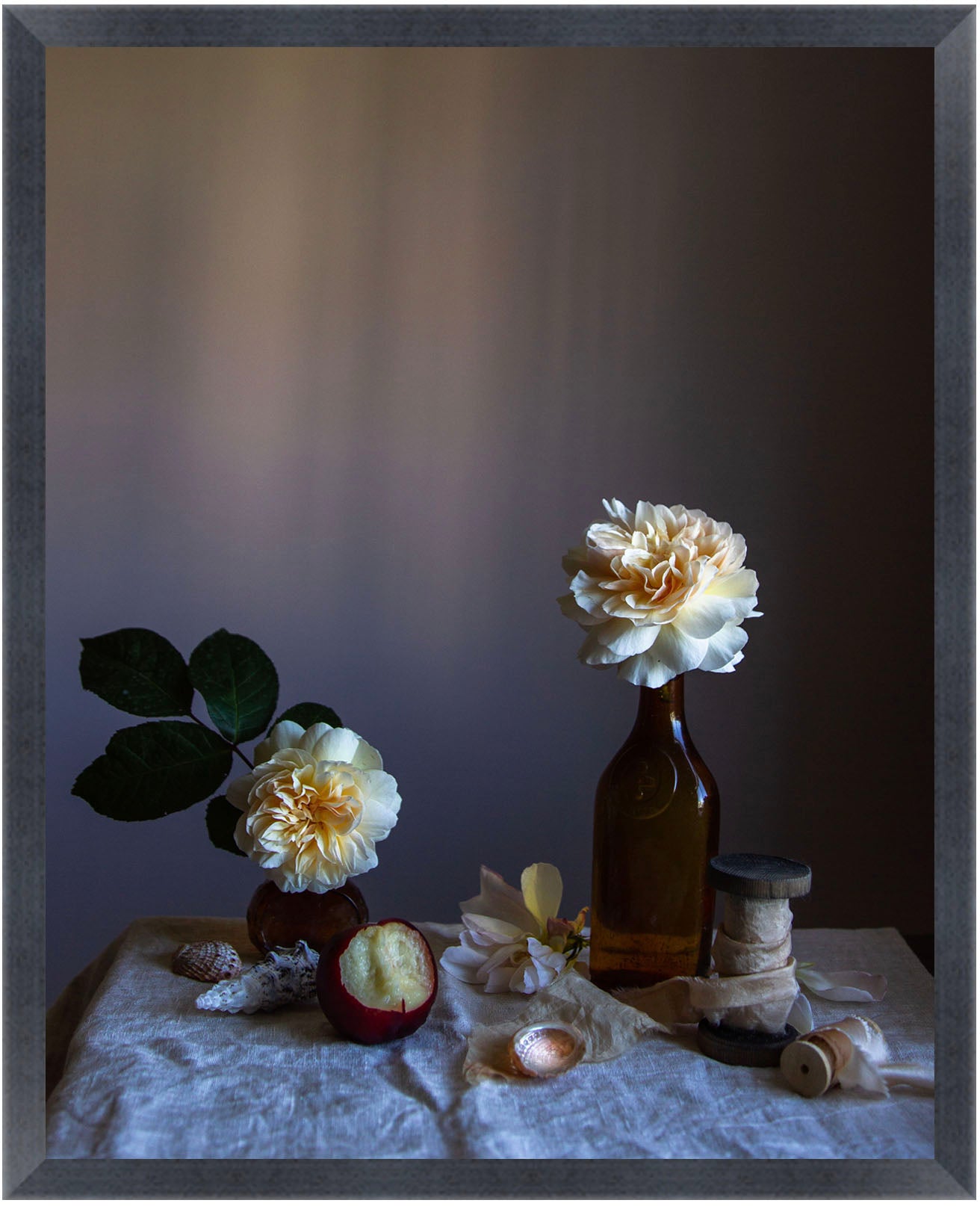 Framed Still life arrangement with flowers in bottles on a textured surface. Flower artwork