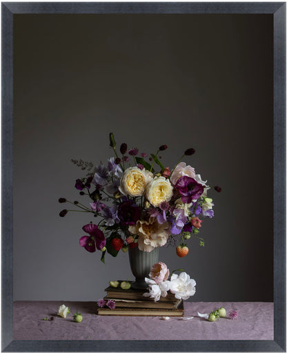 Floral arrangement in a vase with a small statue on a dark background.   Botanical picture