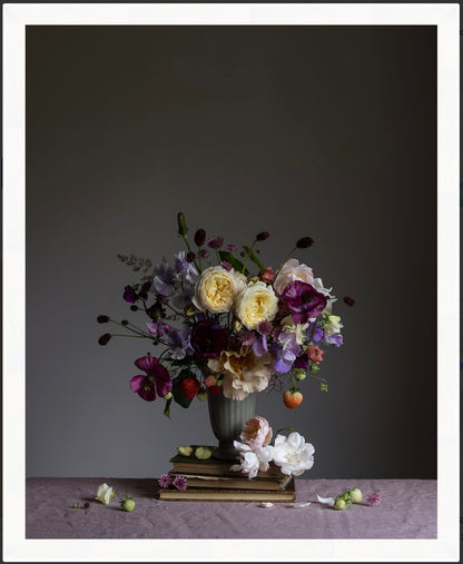 Floral arrangement in a vase on a table with a dark background.   Botanical print