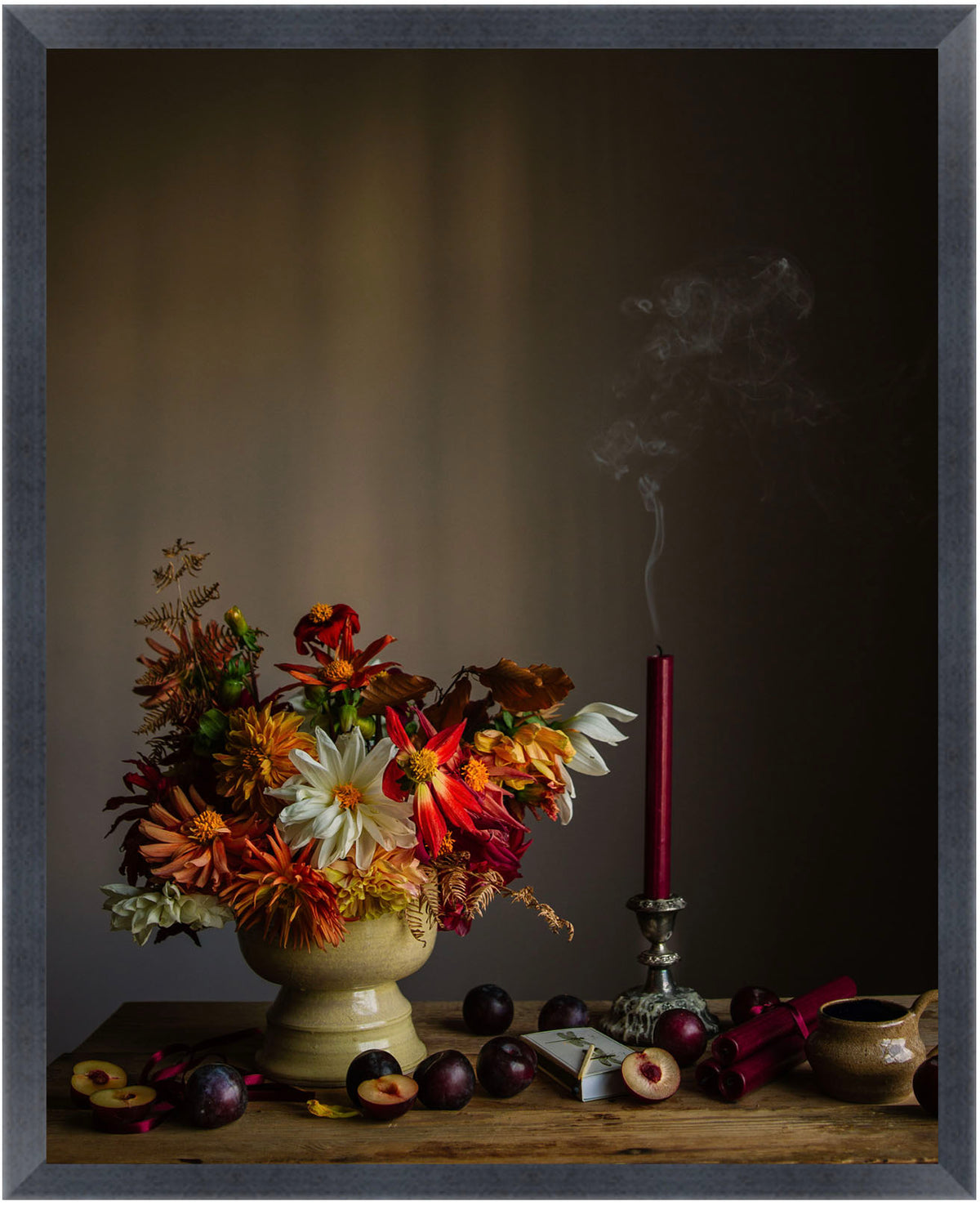 Framed still life with flowers and fruits on a dark background