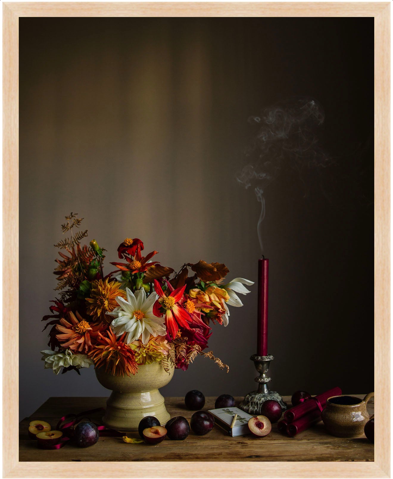 Framed Still life arrangement with flowers, fruits, and a smoking candle on a dark background