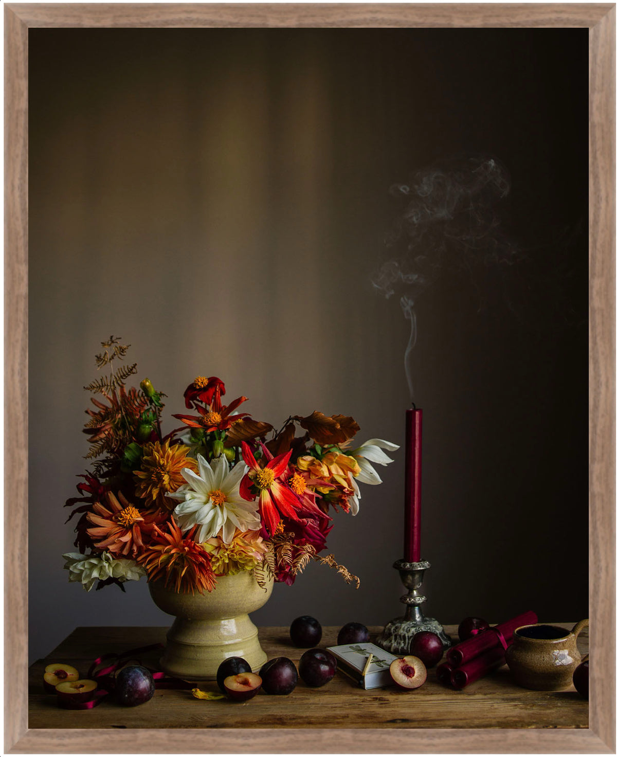 Framed botanical picture with flowers, candles, and fruits on a dark background