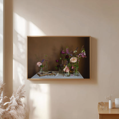 Framed artwork of foxgloves and roses by Emma Harris on a wall with soft lighting